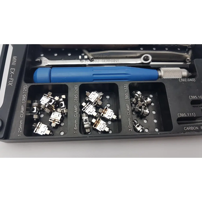 Black plastic tool organizer with dental clamps and blue screwdriver in synthes mini external fixation set