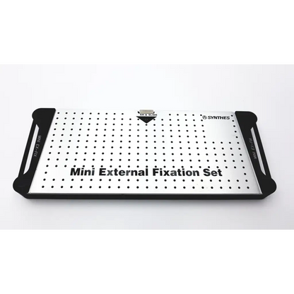 Synthes mini external fixation set with silver and black perforated metal plate for orthopedic use