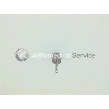 Silver surgical implant with spherical head and threaded shaft from synthes swiss colibri 532.031