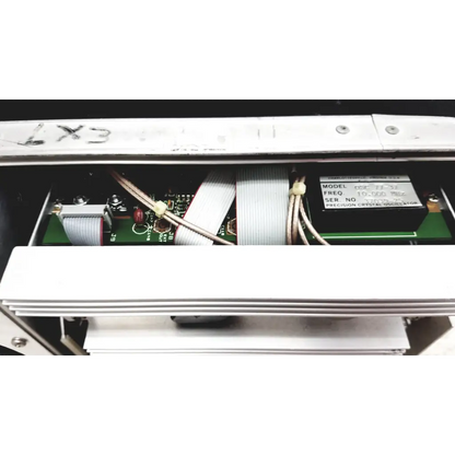 White electronic device interior with green circuit board and silver cables in systron donner mrc 6500 microwave repeater test set