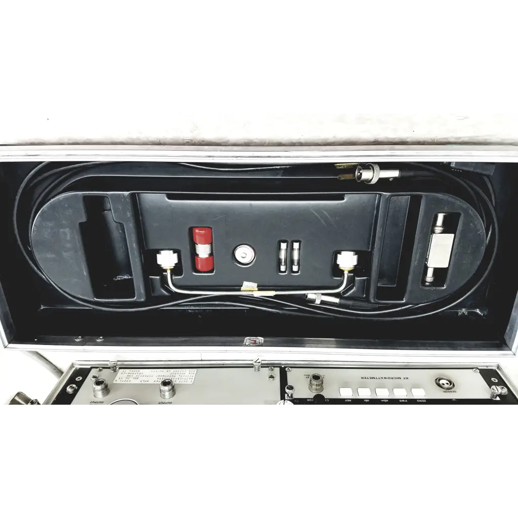 Black molded plastic case with systron donner mrc 6500 microwave repeater test set featuring red components and cables