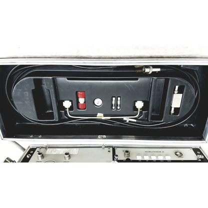 Black molded plastic case with systron donner mrc 6500 microwave repeater test set featuring red components and cables
