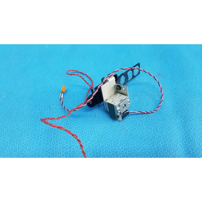 Silver and black Takano SAP1-T115A rotary solenoid optical filter slider with red-and-white striped wires for retinal camera