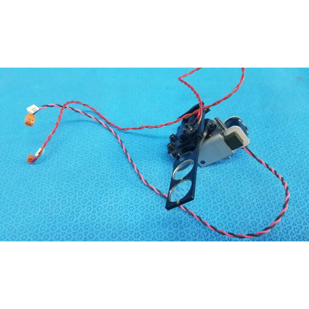 Black and silver takano sap1-t115a rotary solenoid optical filter slider with red and black striped wiring for retinal camera