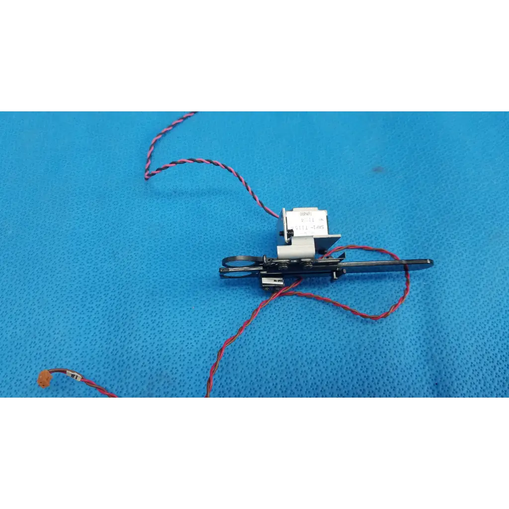 Black Takano SAP1-T115A rotary solenoid optical filter slider with red and black wiring for Topcon retinal camera