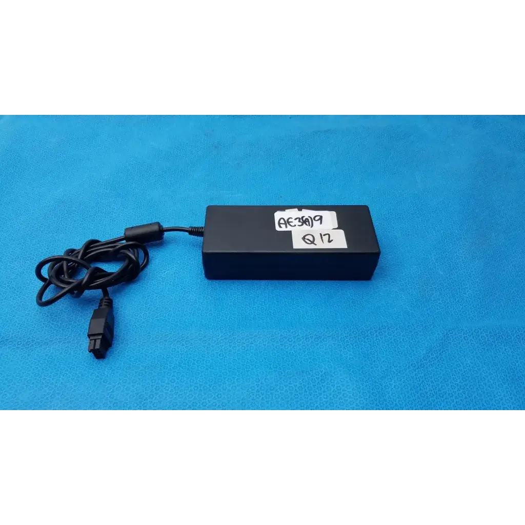 Black rectangular da-150a12 power supply with coiled black cable and 8-pin connector for te connectivity devices
