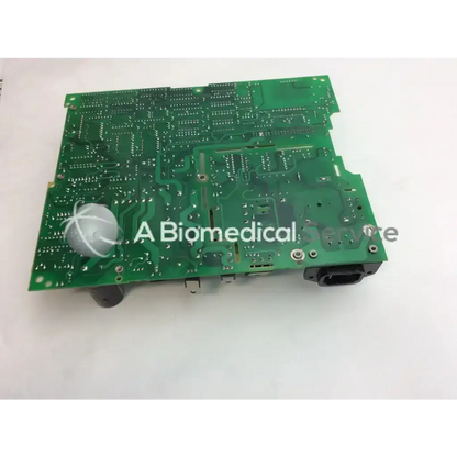 Green printed circuit board with silver soldered components and white sensor on tectrol tc33m-6806 board