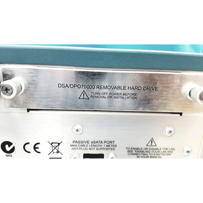 Silver metallic label with engraved text and warning symbols on the removable hard drive of tektronix awg7122c arbitrary waveform generator