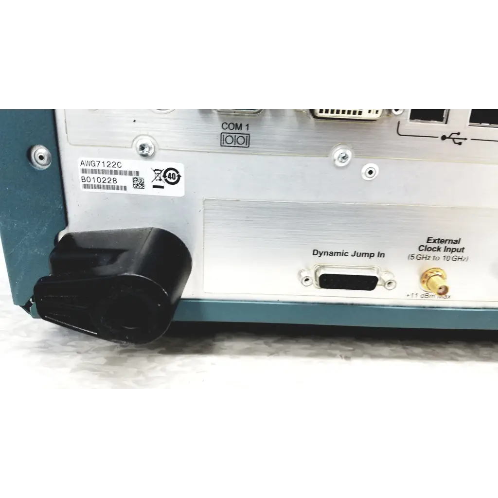 Silver and teal Tektronix awg7122c arbitrary waveform generator with black plastic connector housing