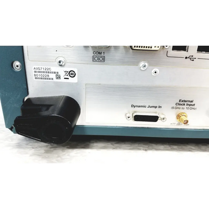 Silver and teal Tektronix awg7122c arbitrary waveform generator with black plastic connector housing