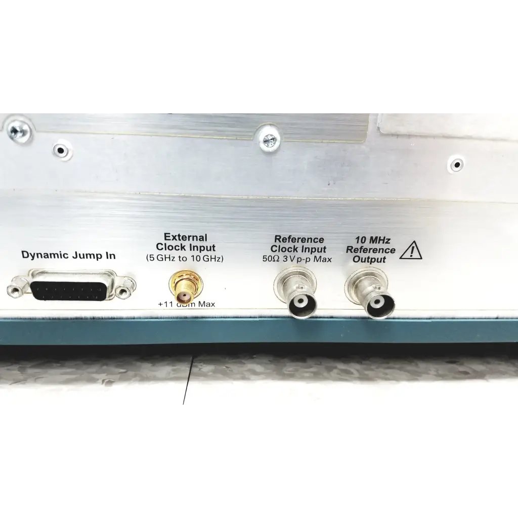 Silver electronic test equipment panel with d-sub, gold coaxial, and bnc connectors on the back of tektronix awg7122c arbitrary waveform generator