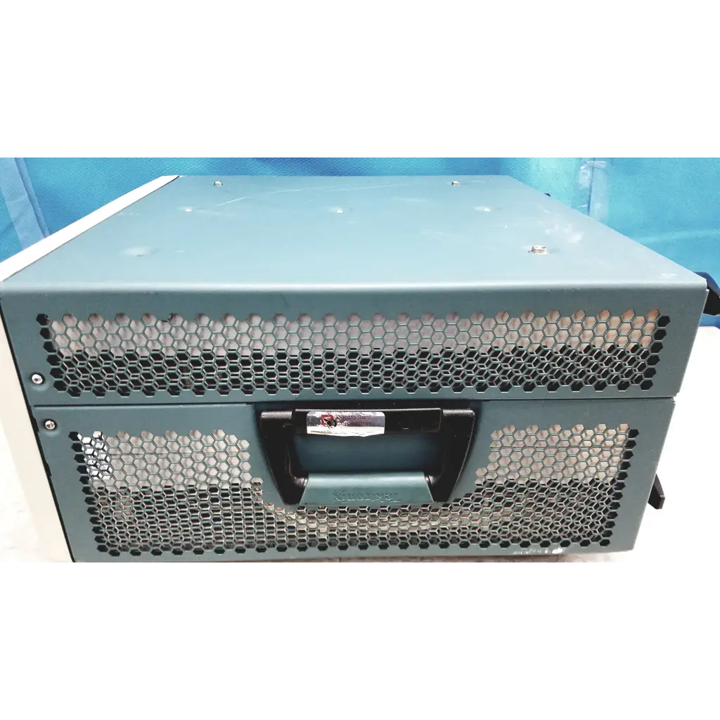 Teal-colored metal server rack with black handle and hexagonal ventilation grilles on tektronix awg7122c arbitrary waveform generator