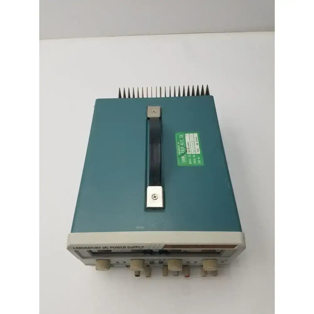 Teal-colored tektronix ps280 triple output dc power supply with beige control knobs and a black handle