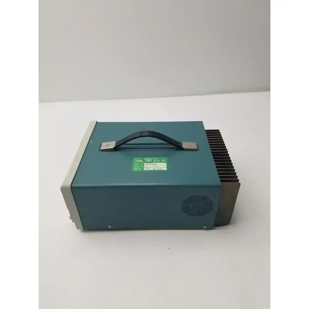 Teal-colored tektronix ps280 triple output power supply with black handle and metal heat sink fins for industrial use