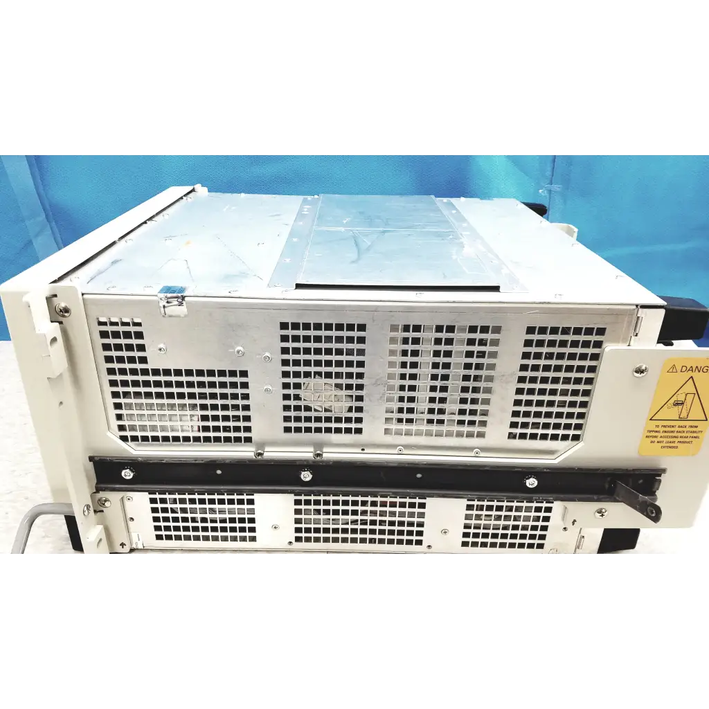 White metal tektronix rsa6106a real-time spectrum analyzer rack with black ventilation grilles and yellow warning label