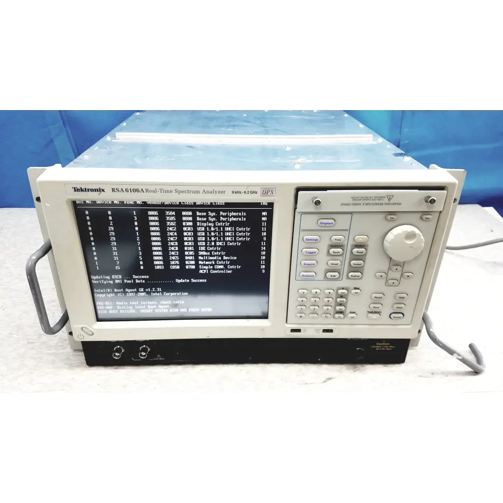 Beige tektronix rsa6106a real-time spectrum analyzer with black screen showing technical data and keypad panel
