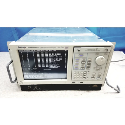 Beige tektronix rsa6106a real-time spectrum analyzer with black screen showing technical data and keypad panel
