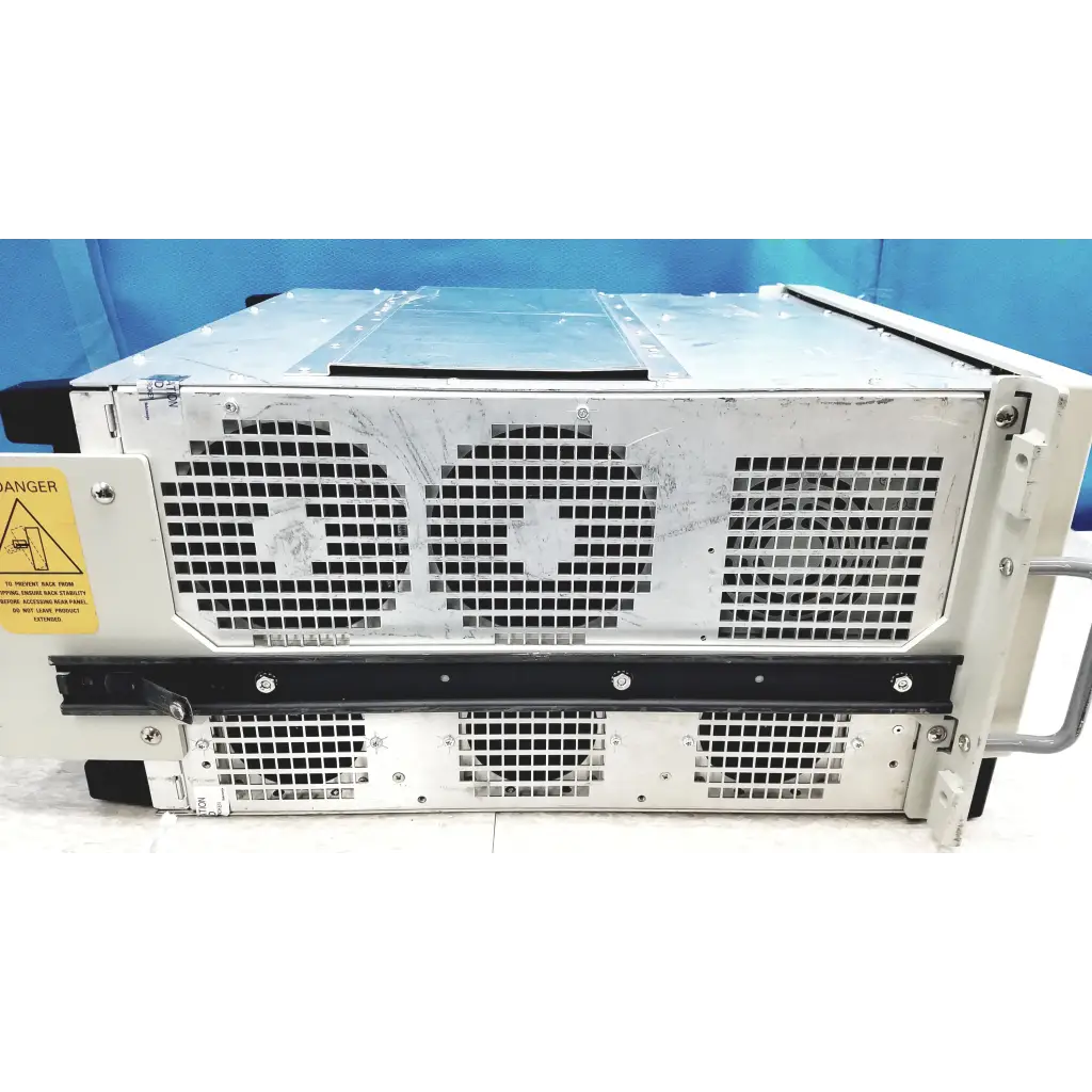 Silver metallic tektronix rsa6106a real-time spectrum analyzer server rack with black grilles and yellow warning label side view