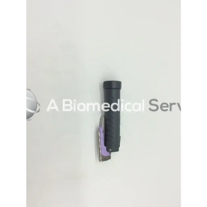 Black textured handle with purple and silver surgical stapler attached side on teleflex rusch trulite mill 0
