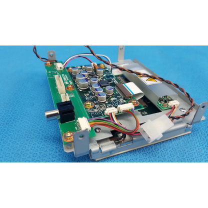 Green printed circuit board with silver capacitors and multicolored wiring in gray plastic casing for lcd monitor control