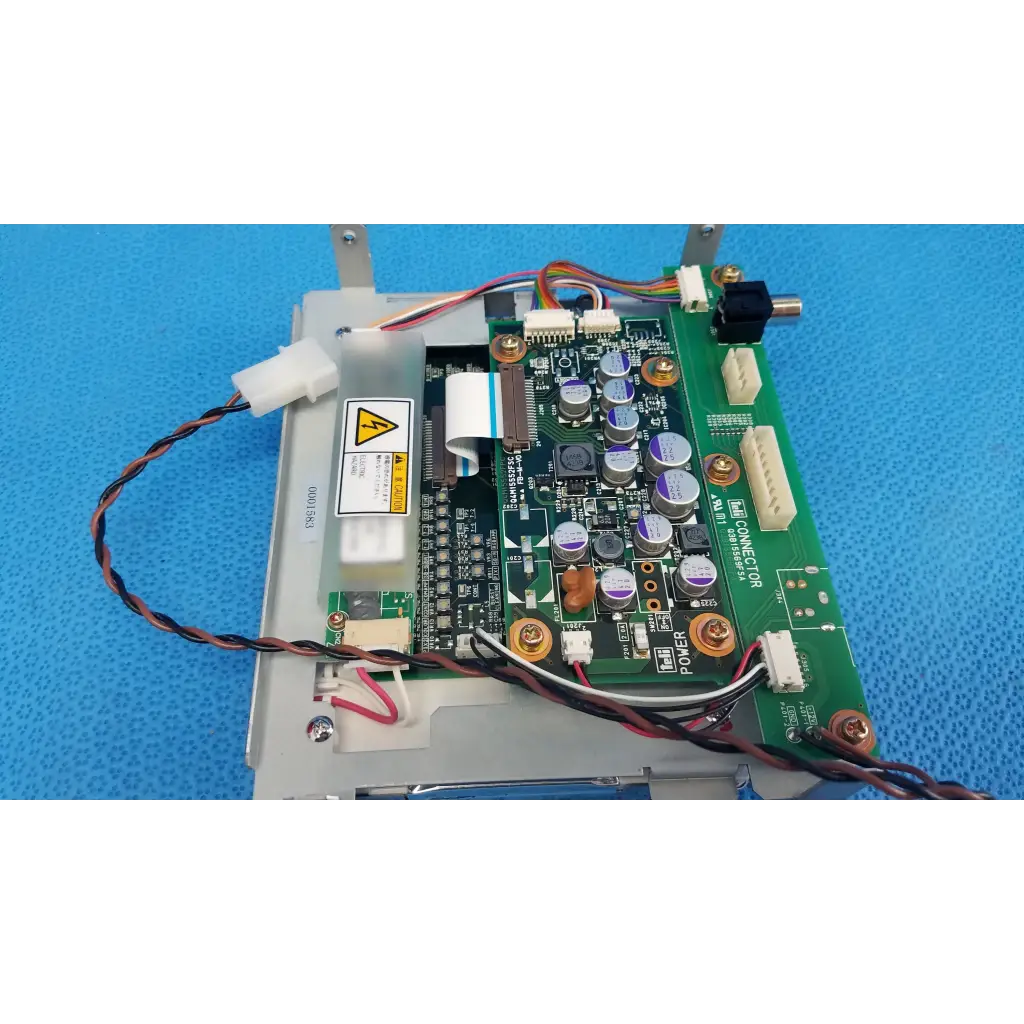 Green circuit board with silver and purple capacitors and connectors on gray metal chassis for teli lcd monitor control board