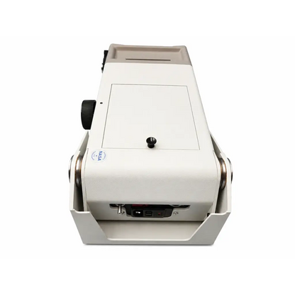 White nasa-branded currency counting machine with black knobs and metallic rollers beside biomed certified titmus 2s vision screener