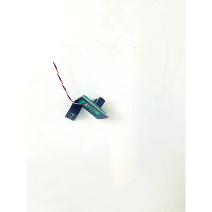 Black and green electronic sensor module with red and black wire on topcon board bbcb3-8b 22523sm