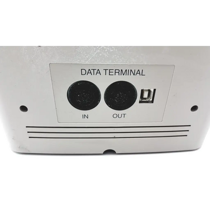 Backside of white plastic Topcon EZ 200 advance automatic lensmeter with black circular ports and rectangular connector slot