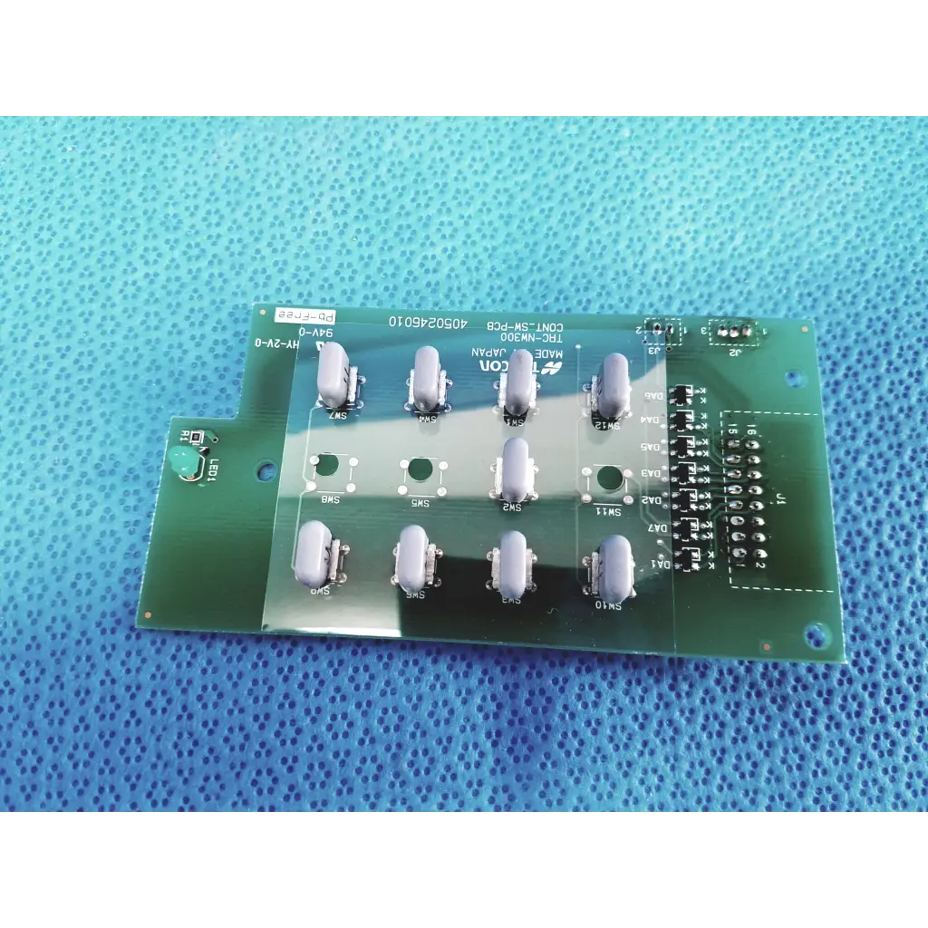 Green printed circuit board with ten gray toggle switches and black connectors for topcon trc-nw300 control switch pcb