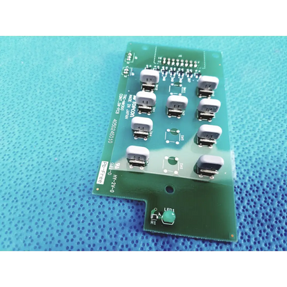Green printed circuit board with gray rectangular components and white labeling of topcon trc-nw300 control switch pcb board