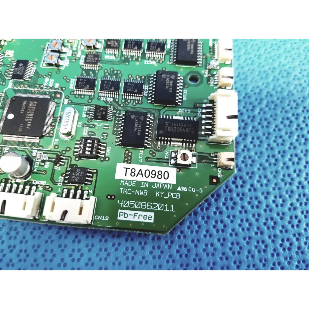 Green pcb control circuit board with black integrated circuits labeled t8a0980 made in japan for topcon trc-nw8