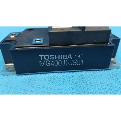 Black toshiba mg400j1us51 igbt power module with metallic mounts and blue label for retinal camera use