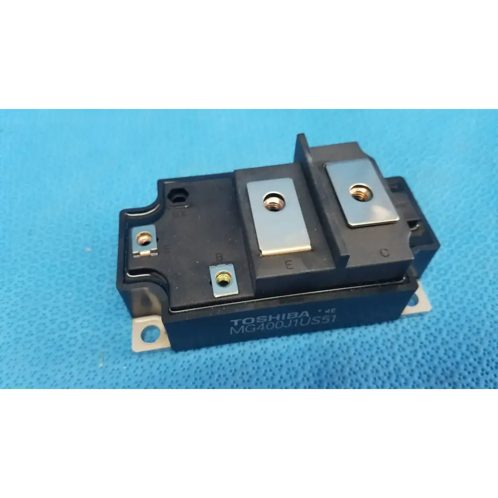 Black toshiba mg400j1us51 igbt power module with silver metal terminals and gold screw heads for retinal camera use