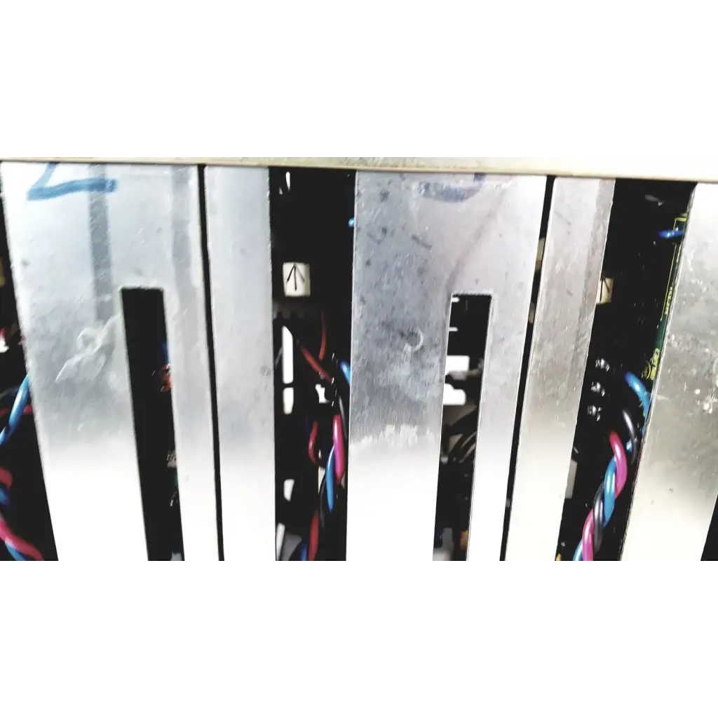Silver metal server rack with vertical slats and visible wiring showing the back of toshiba ra power rad92-1008 power supply