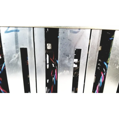 Silver metal server rack with vertical slats and visible wiring showing the back of toshiba ra power rad92-1008 power supply