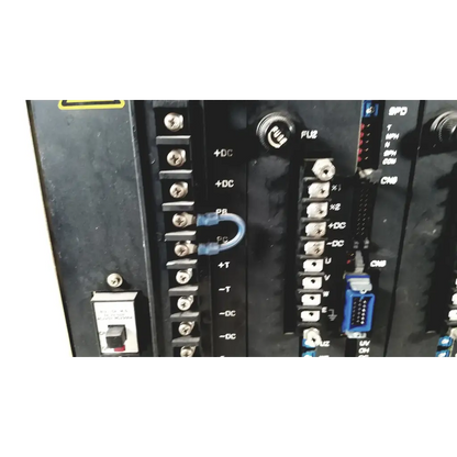 Blue plastic u-shaped terminal connector attached to black industrial control panel on toshiba ra power rad92-1008 power supply