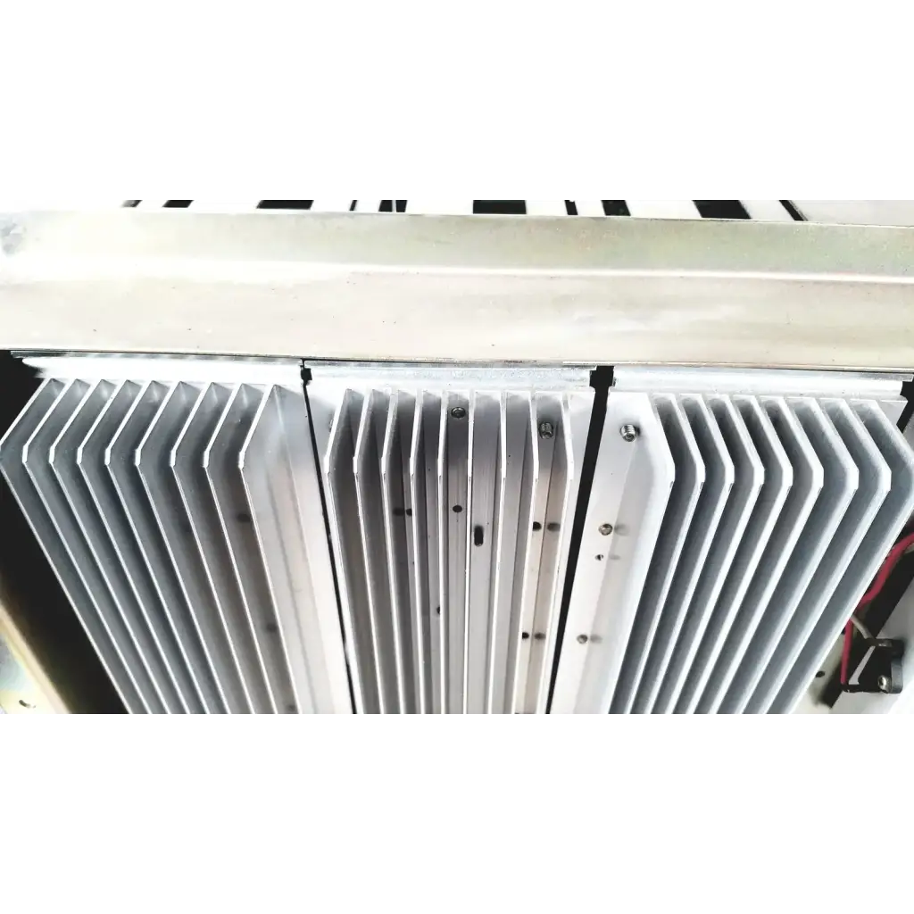 Silver-colored aluminum heat sink with parallel fins and mounting screws on toshiba ra power rad92-1008 power supply