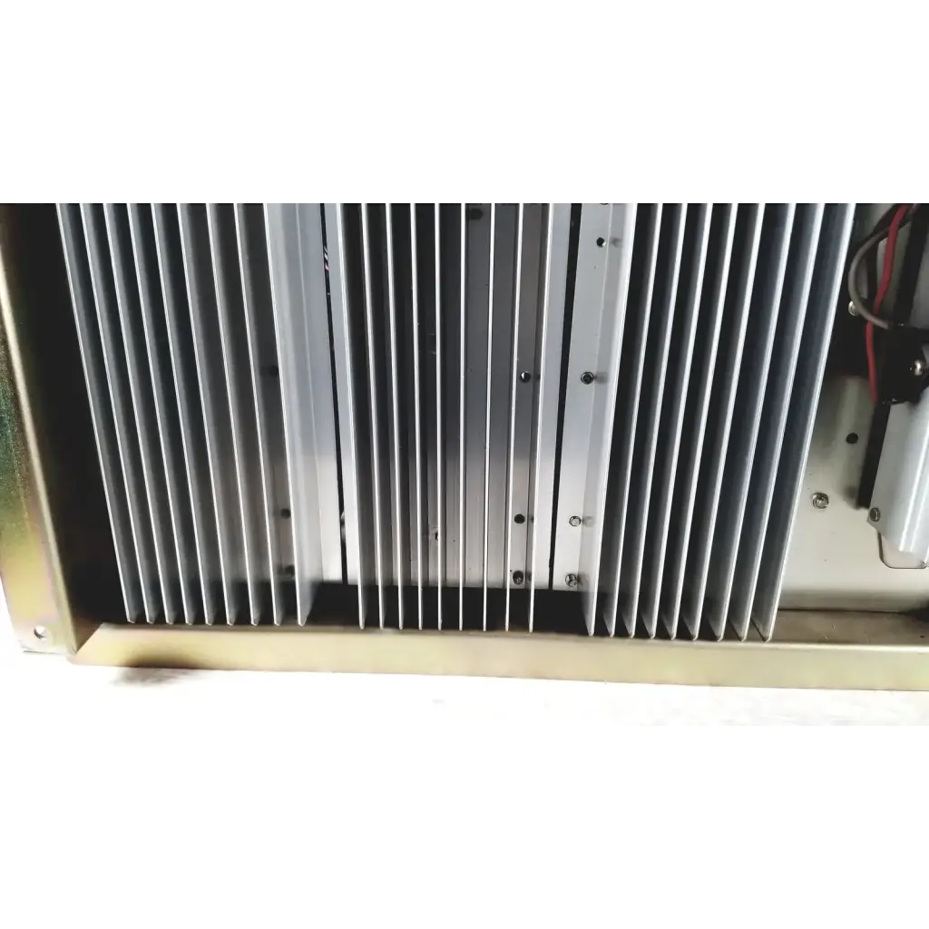 Silver metallic heat sink with vertical fins and mounting screws on toshiba ra power rad92-1008 power supply