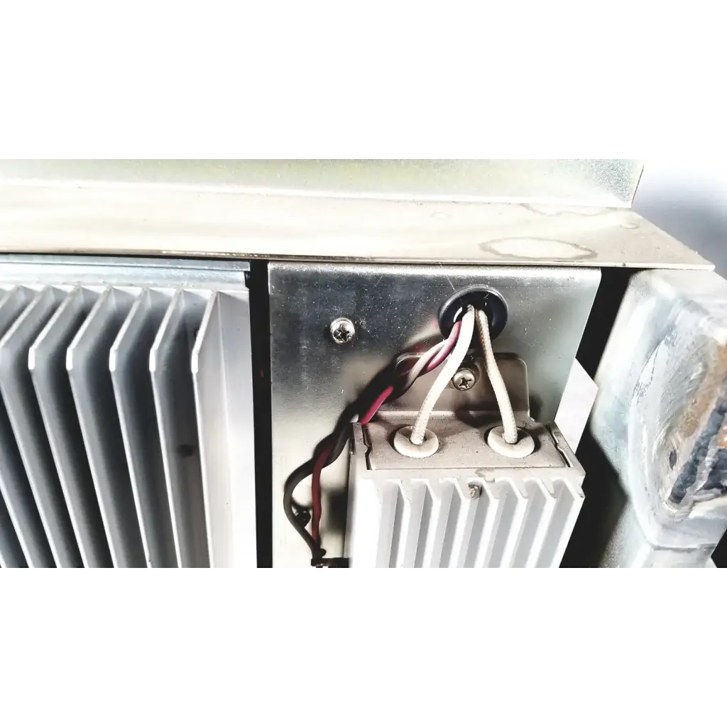 Silver metallic heat sink with vertical fins and wiring harnesses on the back of toshiba ra power rad92-1008 power supply