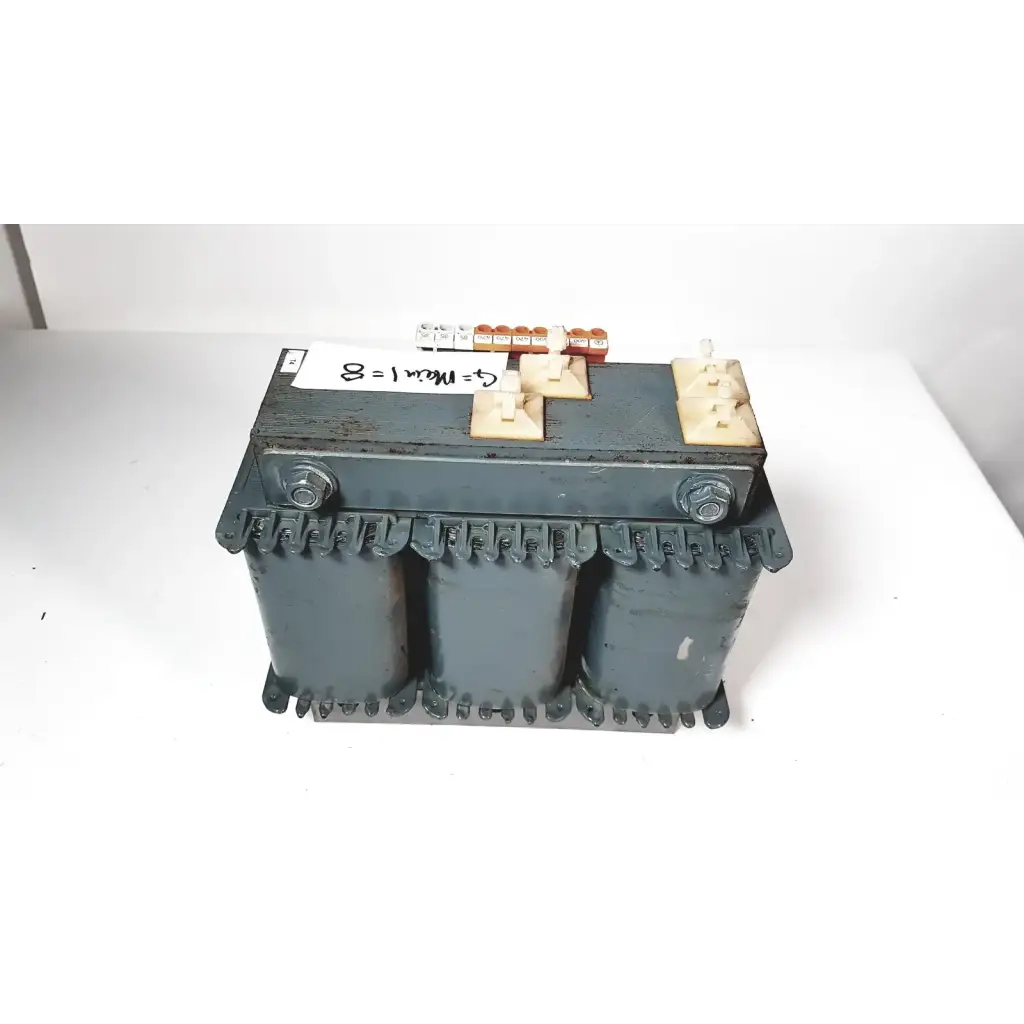 Dark gray industrial trafo jordi ch-4950 huttwil transformer with three cylindrical cores and beige terminal blocks featuring a handwritten label