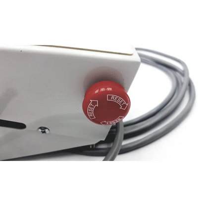 Red circular reset button with white reset text and arrows on white plastic housing of transmotion medical control box 58311-001 rev h