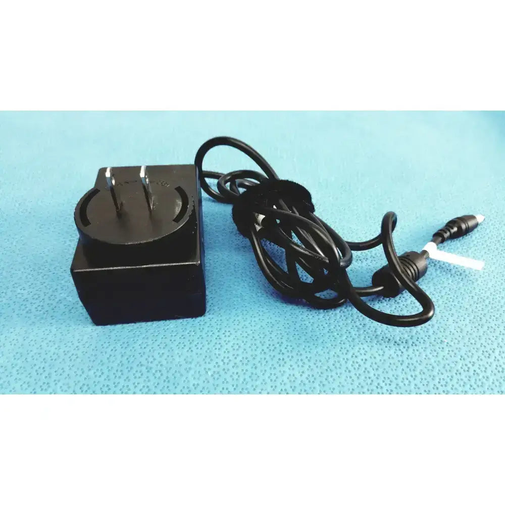 Black rectangular fsp015-rcmm trumpower medical power supply adapter with coiled cable and two distinct connectors