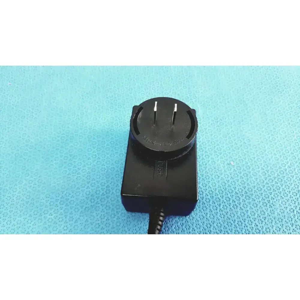 Black plastic TrumPower medical power supply AC/DC adapter fsp015-rcmm with australian circular two-prong plug and coiled cable