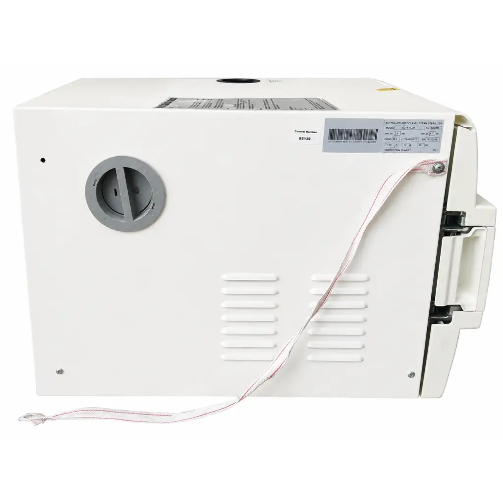 White plastic biomed certified Tuttnauer EZ11 Plus autoclave steam sterilizer with gray knob and red white power cord