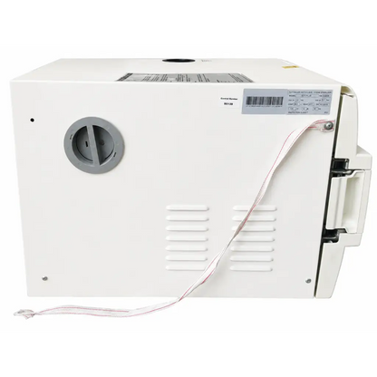 White plastic biomed certified Tuttnauer EZ11 Plus autoclave steam sterilizer with gray knob and red white power cord