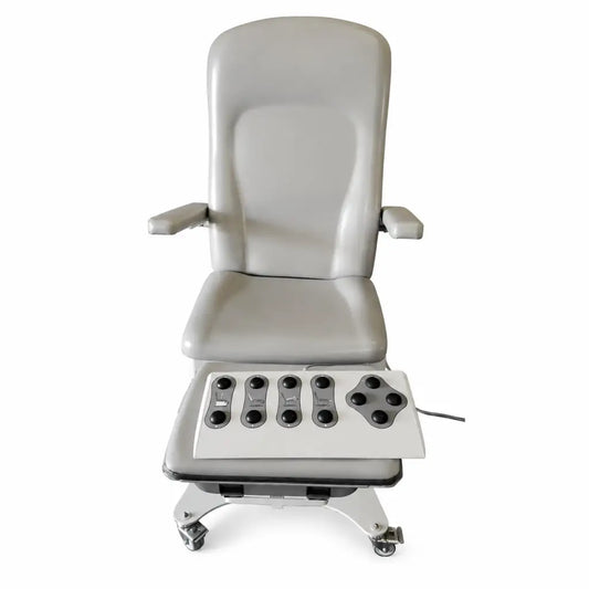 Gray upholstered UMF Medical 5016 power medical exam chair with integrated foot massage pad and black control buttons