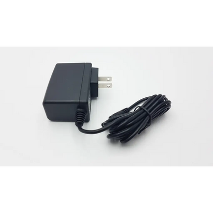 Black plastic upbright adapter xtd-1501000 ac5-383 with coiled power cord and two-prong plug for ac dc use