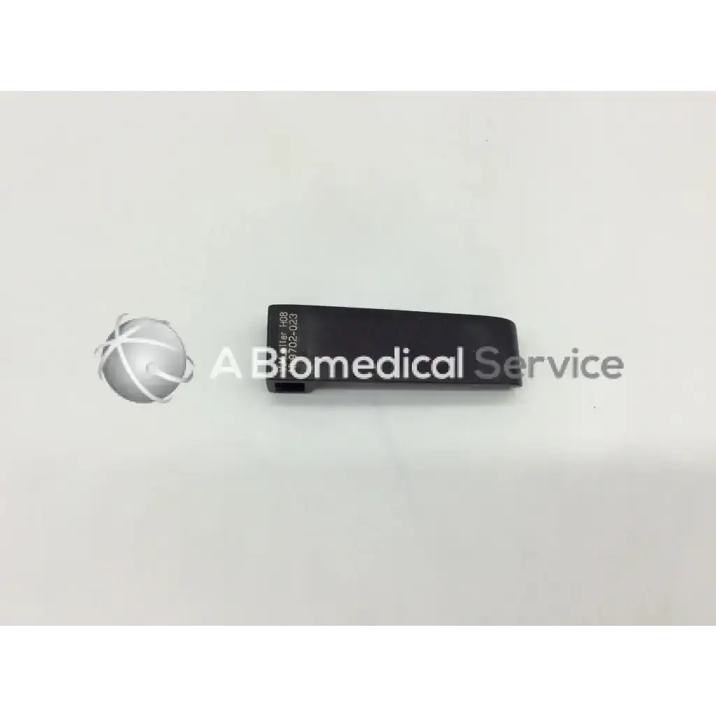 Black rectangular v mueller nl9702-023 retractor blade with engraved serial number and model identifier on back side