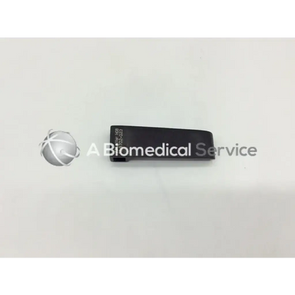 Black rectangular v mueller nl9702-023 retractor blade with engraved serial number and model identifier on back side