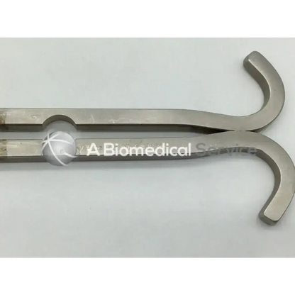 Silver-toned mueller su3032 surgical dixon center blade with polished metal finish and curved handles for surgical use